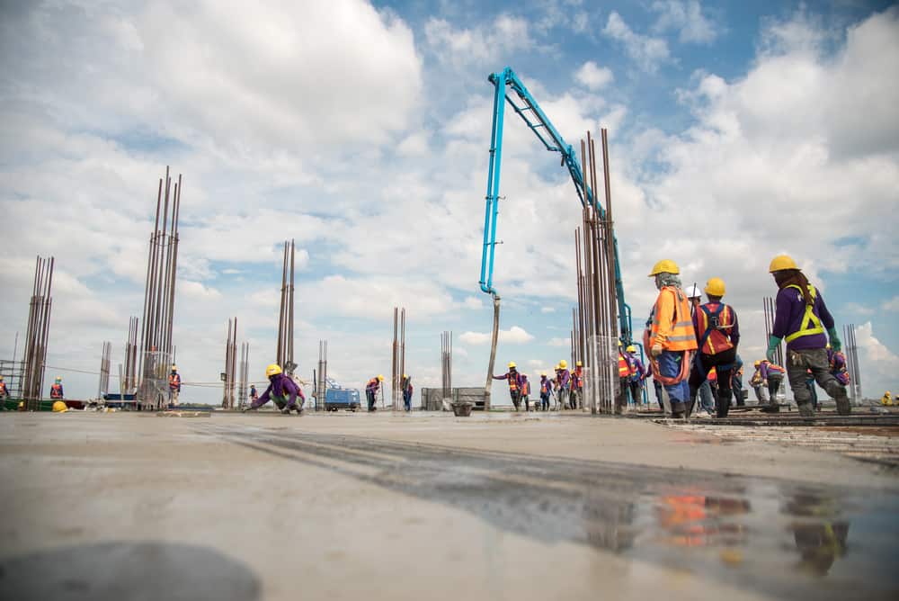 Workers and Engineers are working to build a commerical building in a commercial site